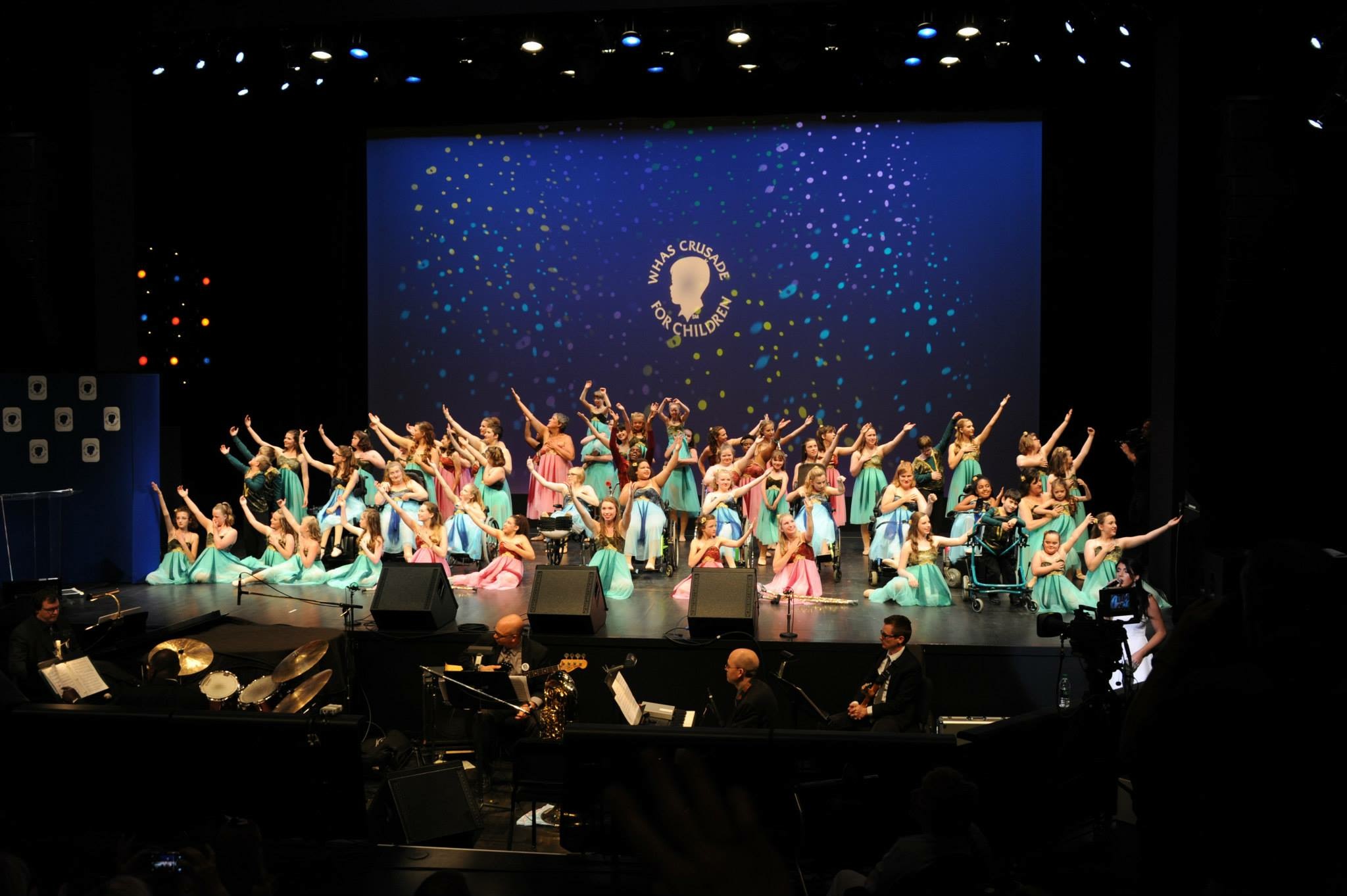 The Miracle Dancers performance team in coordinated costumes during a performance